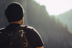 A healthy diet and exercise can prevent Type 2 Diabetes. Image shows a man with a backpack on a hike.